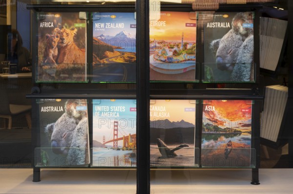 Trailfinders travel agency window display posters, Exeter city centre, Devon, England, UK