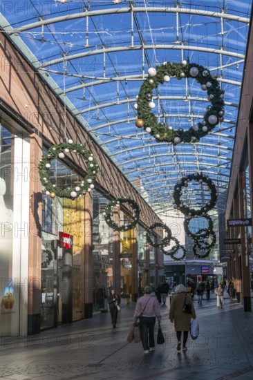 Christmas shoppers inside covered shopping street, Princesshay shopping centre, Exeter, Devon, England, UK