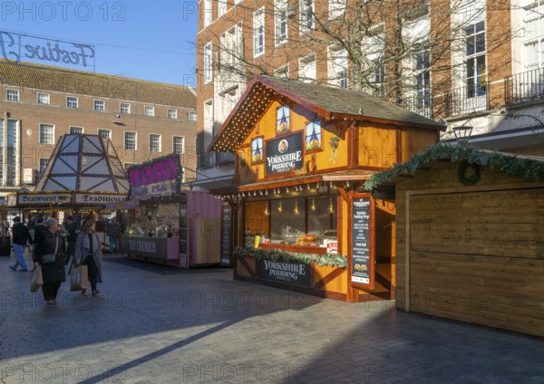 Christmas market wooden shed market stalls in city centre, Exeter, Devon, England, UK - Yorkshire Pudding