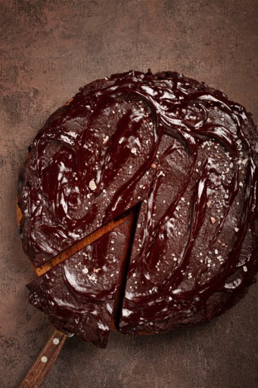 Chocolate cake, round cake, on a brown background, top view, homemade cakes, no people