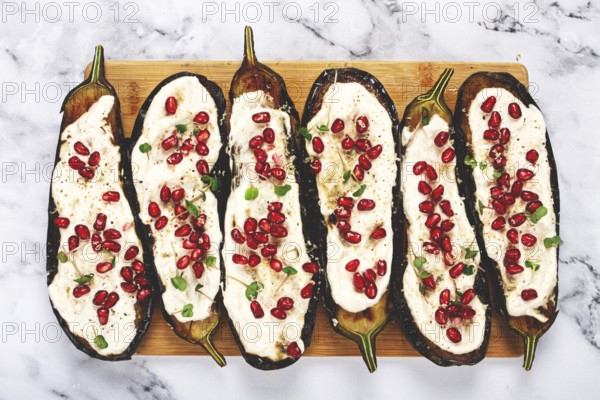Fried eggplant with sauce, decorated with microgreens and pomegranate seeds, eggplant appetizer, top view, homemade, no people