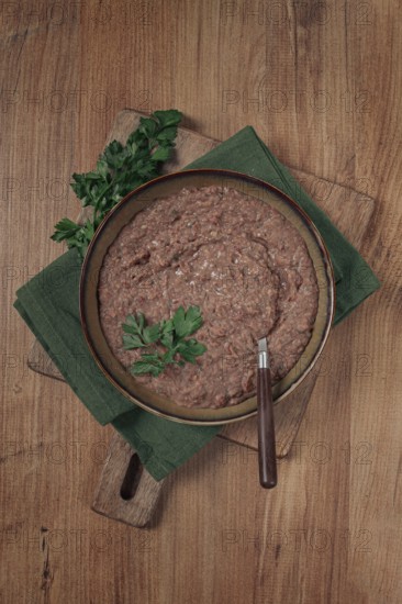 Red bean lobio, a traditional Georgian dish, on a wooden table, homemade