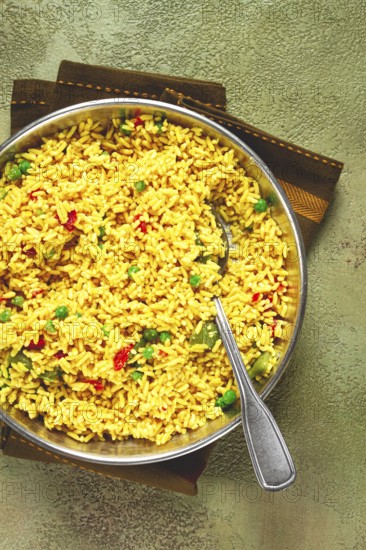 Rice with saffron and vegetables, in a frying pan, top view, homemade, no people