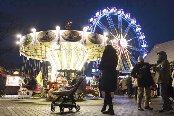 Children's carousel and Ferris wheel at the Berlin Christmas market on Alexanderplatz, Berlin, 24.11.2025