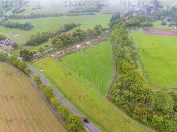 Aerial view of a green landscape with construction site and adjacent road, PV Freifaechenanlage construction, Weil der Stadt, Germany