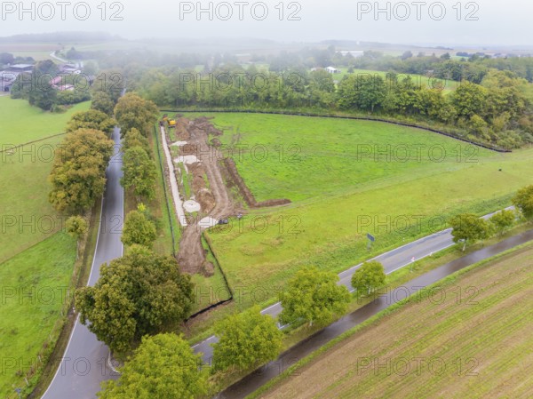 Aerial view of a construction site with roads and trees in a natural environment, Bau PV Freifaechenanlage, Weil der Stadt, Germany