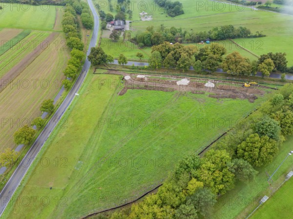 Aerial view of a green area with construction and surrounding trees, PV Freifaechenanlage construction, Weil der Stadt, Germany