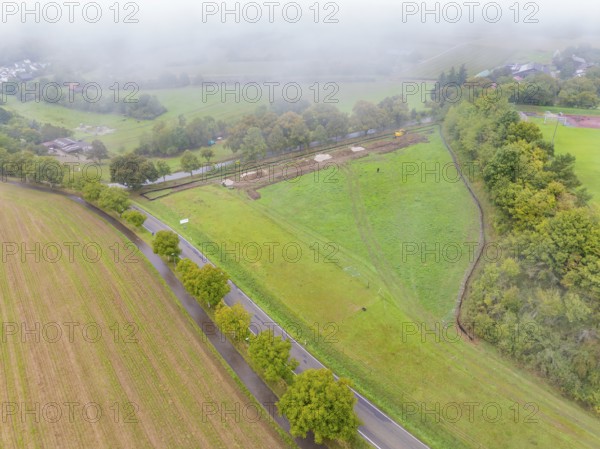 Aerial view of a foggy rural landscape with fields and roads, construction of a PV open-air system, Weil der Stadt, Germany