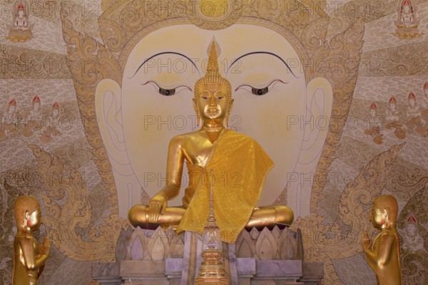 Golden Buddha statue with tunic, Bhumispara mudra, Buddha Gautama at the moment of enlightenment, art hall with exhibition of non-traditional works of art, most of which follow modern art trends such as minimalism and abstraction, Wat Sitthawararam, Bangkok, Thailand