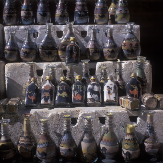 Souvenir stand, bottles filled with colorful sand, Nabataean rock town Petra, Jordan
