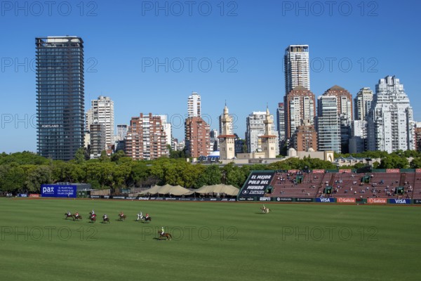 Scene at the 132nd Argentinean Open Polo Championship (Spanish 132nd Abierto Argentino de Polo de Palermo) in the Polo Stadium playing between La Irenita la Hache and La Ensenada with the skyline of Buenos Aires, Argentina