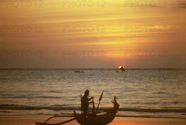 Fisherman with dugout, Kuta, sunset, Bali, Indonesia
