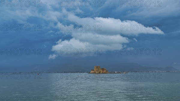 Bourtzi island fortress, a castle located on a small island surrounded by calm waters under a changing sky, Nauplion, Nafplion, Peloponnese, Greece