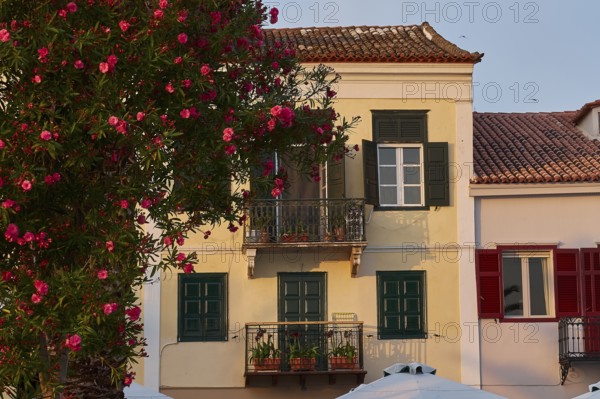 Old town of Nauplion, Traditional house with red shutters and flowers in evening sunlight, Nauplion, Nafplion, Peloponnese, Greece