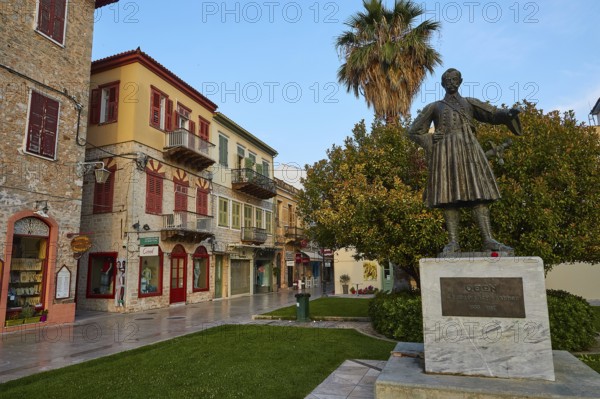 Old town of Nauplion, historical statue in a cozy street surrounded by old buildings and palm trees, Nauplion, Nafplion, Peloponnese, Greece