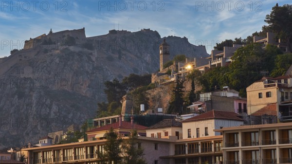 Palamidi fortress, town with a castle on a hill in the morning light, surrounded by old buildings and trees, Nauplion, Nafplion, Peloponnese, Greece
