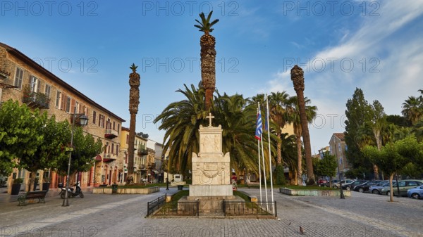 Old town of Nauplion, monumental town square with palm trees and a monument under a clear sky, Nauplion, Nafplion, Peloponnese, Greece
