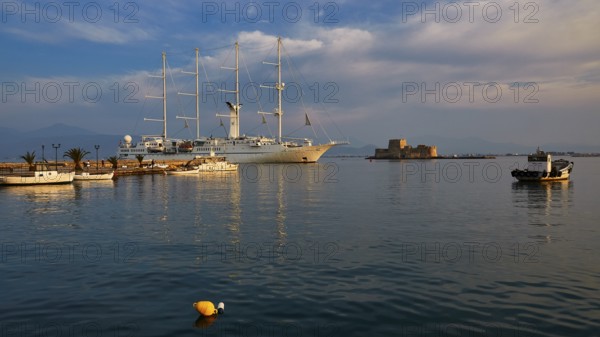 Bourtzi island fortress, port of Nauplion, A large sailing ship in the harbor with calm water and a small fortress in the background, Nauplion, Nafplion, Peloponnese, Greece
