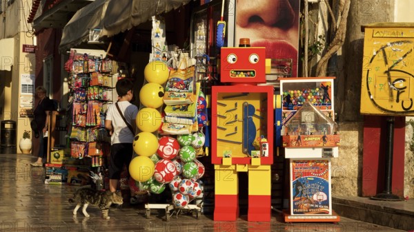 Old town of Nauplion, A colorful toy store with a retro robot and balloons in a sunny street, Nauplion, Nafplion, Peloponnese, Greece