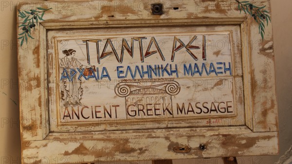 Old Town of Nauplion, An antique wooden sign with Greek writing and decorative motifs, Nauplion, Nafplion, Peloponnese, Greece