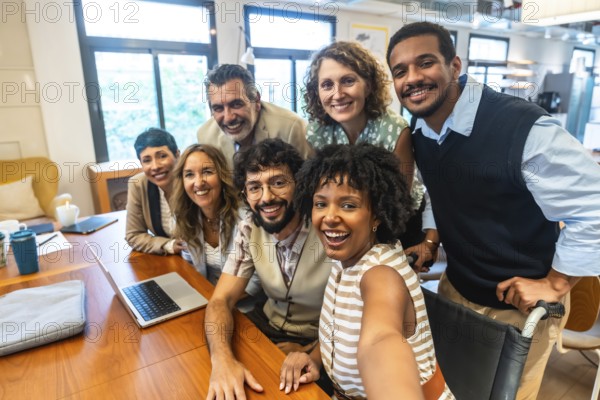 Diverse and inclusive business team smiling together during a casual meeting in a modern coworking office, actively collaborating and fostering a positive work environment