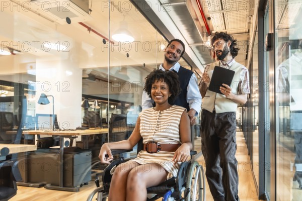 Diverse business colleagues pushing a smiling woman in a wheelchair through a contemporary office hallway, showcasing teamwork, accessibility, and an inclusive work environment