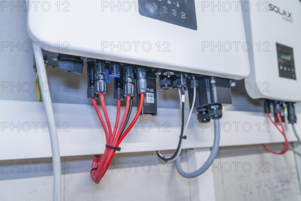 Solax device with red and grey cables in a technical environment