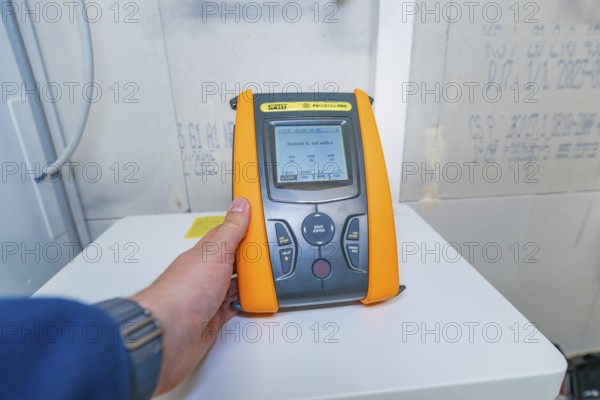 Person operates PVCheck PRO with a display that shows information