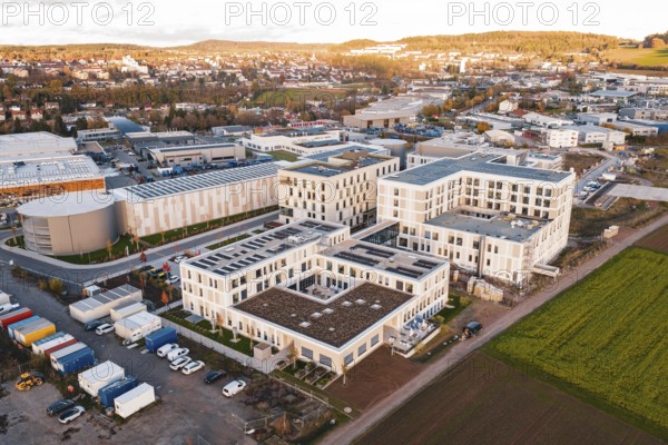Aerial view of a city panorama with modern buildings and adjacent fields, new hospital, Calw health campus, Black Forest, Germany