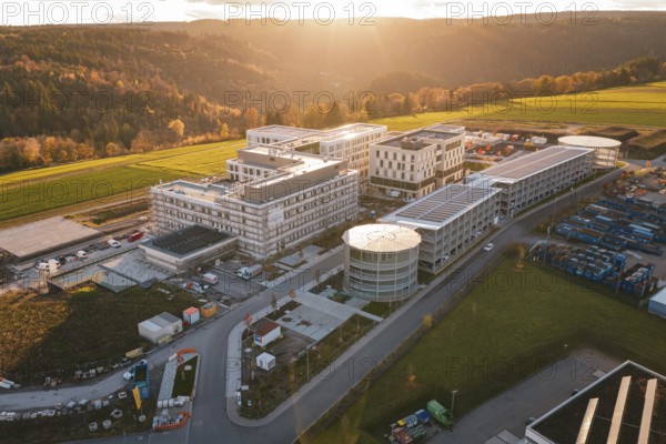 Aerial view of a modern building complex in rural area at sunset, new hospital, Calw Health Campus, Black Forest, Germany