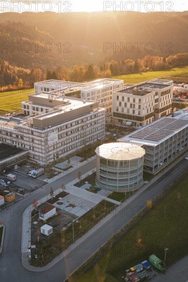 Modern buildings in autumn light with surrounding nature and gentle sunset, new hospital, Calw Health Campus, Black Forest, Germany