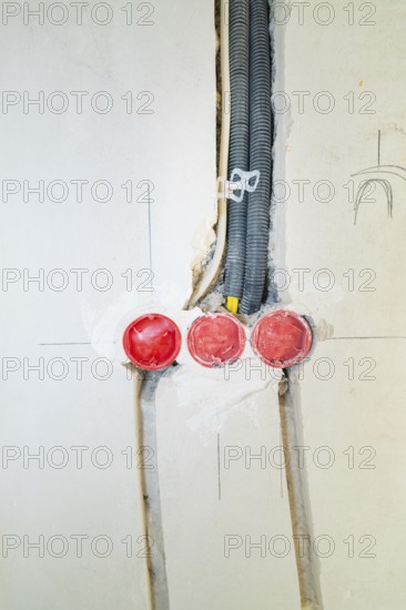 Three sockets built into the wall, new cable installation during renovation