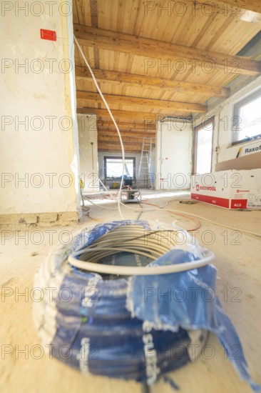 Cable reel and electrical material in a spacious attic during renovation work