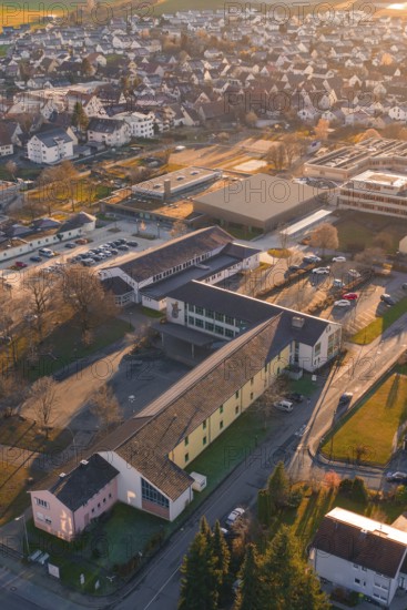 Rural aerial view with school buildings and roads in an autumnal atmosphere, Althengstett, Calw district, Germany