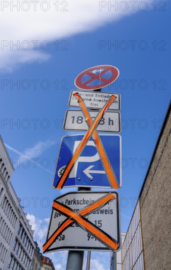Traffic signs invalidated by masking over a side street in Berlin, Germany