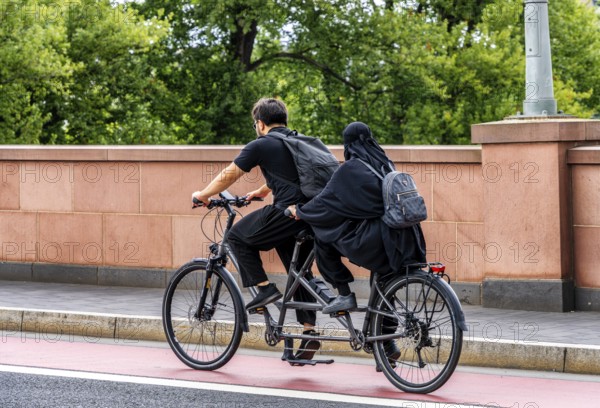 Bicycle tandem with two people on public roads, Frankfurt am Main, Hesse, Germany