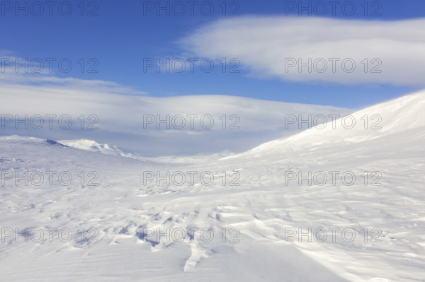 Desolate windswept snow covered Arctic landscape at Mohnbukta, bay at the western shore of Storfjorden in Sabine Land at Spitsbergen, Svalbard