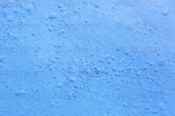 Close-up of air bubbles trapped within glacial ice at Mohnbukta, bay at Storfjorden in Sabine Land at Spitsbergen, Svalbard
