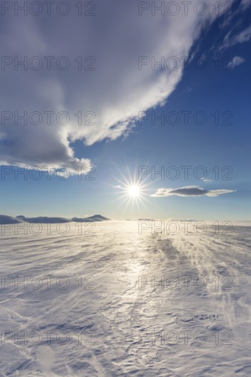 Desolate windswept snow covered Arctic landscape at Mohnbukta, bay at the western shore of Storfjorden in Sabine Land at Spitsbergen, Svalbard