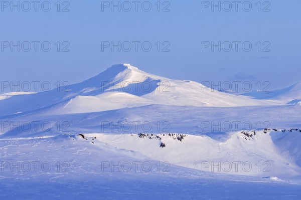 Snow covered mountain in Arctic landscape at Mohnbukta, bay at the western shore of Storfjorden in Sabine Land at Spitsbergen, Svalbard