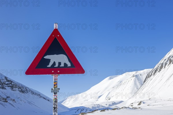 Polar bear warning sign against blue sky, Spitsbergen, Svalbard, Norway
