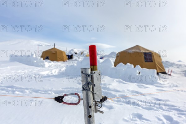 Tripwire warning device armed with blank cartridge from perimeter fence against polar bears at Arctic expedition camp in Spitsbergen, Svalbard