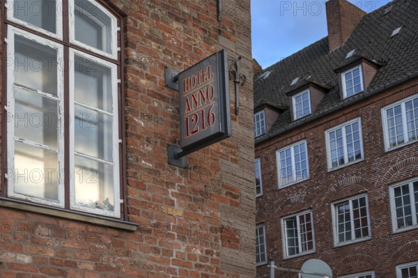 Nose sign from Hotel Anno 1216, historic brick building from the 13th century, Hanseatic City of Lübeck, Schleswig-Holstein, Germany