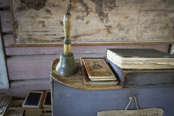 Bell and teacher's desk, old map in the background, 19th century school, Øygarden from Vågå, Maihaugen open-air museum with houses and objects from farms in Gudbrandsdal, Lillehammer am Mjøsa Lake, Fylke Innlandet Municipality, Norway