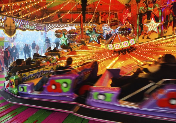 People on the Musik-Express ride at the All Saints Fair, the biggest old town fair in Europe, Soest, North Rhine-Westphalia, Germany