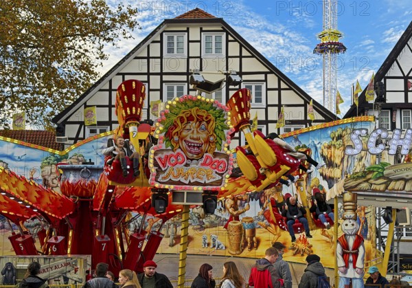 All Saints Fair ride in front of half-timbered houses, largest old town fair in Europe, Soest, North Rhine-Westphalia, Germany