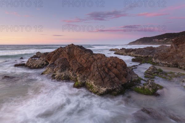 Spectacular sunset over the Pacific Ocean at The Pass with views of Wategos Beach, Byron Bay, Australia