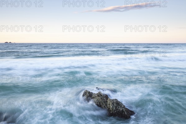View from The Pass: The rocks and waves in the foreground, behind the Nguthungulli Julian Rocks Nature Reserve, Byron Bay, Australia