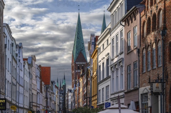 Shopping street with historic houses and the towers of St. Mary's Church, Hanseatic City of Lübeck, Schleswig-Holstein, Germany