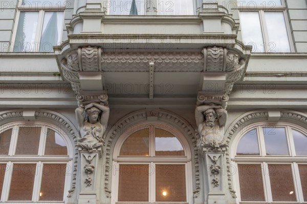 Caryatids at the bottom of a bay window in a historic residential building, 19th century, Hanseatic City of Lübeck, Schleswig-Holstein, Germany